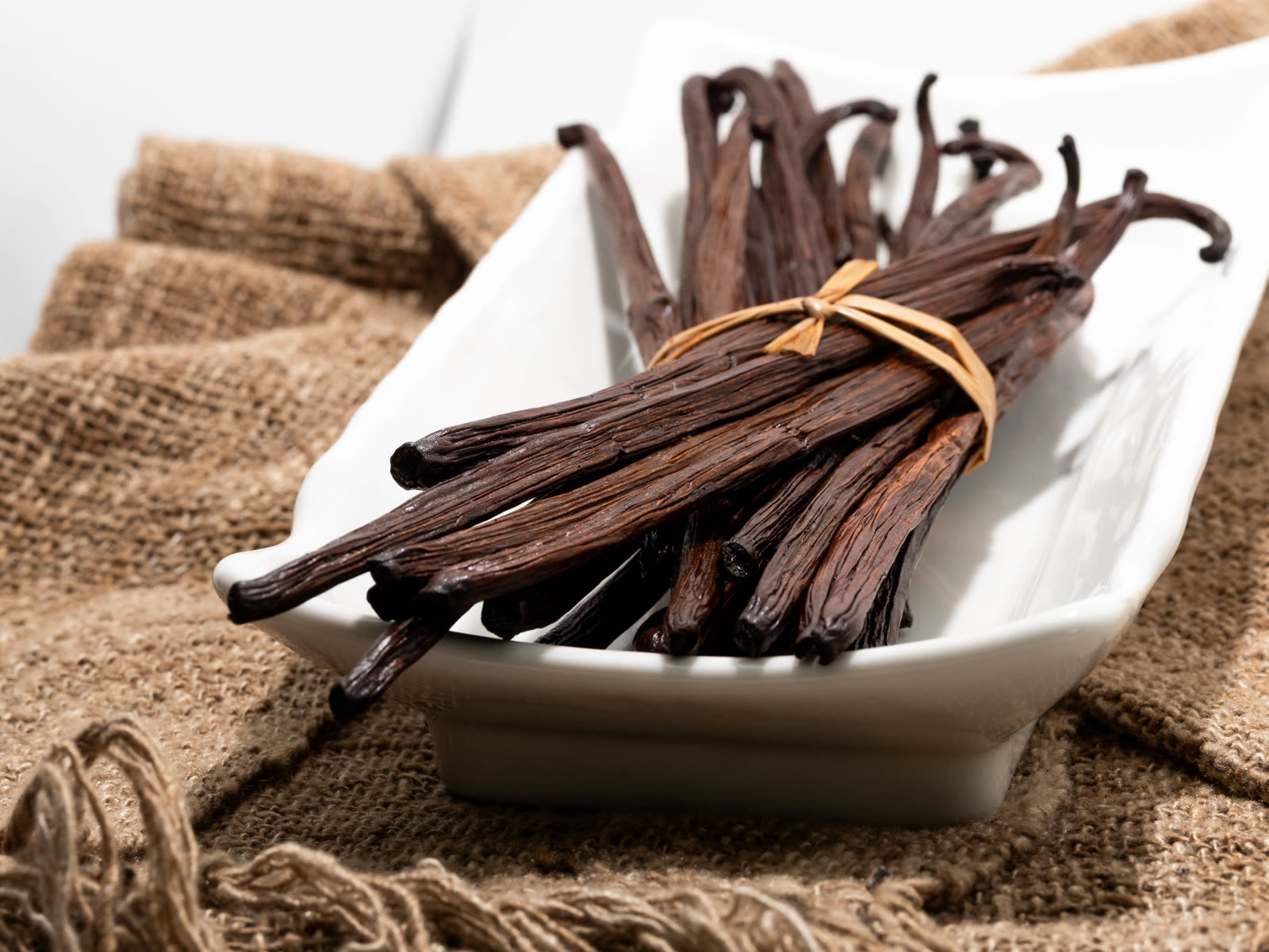 Bundles of cured Madagascar bourbon vanilla beans tied with raffia